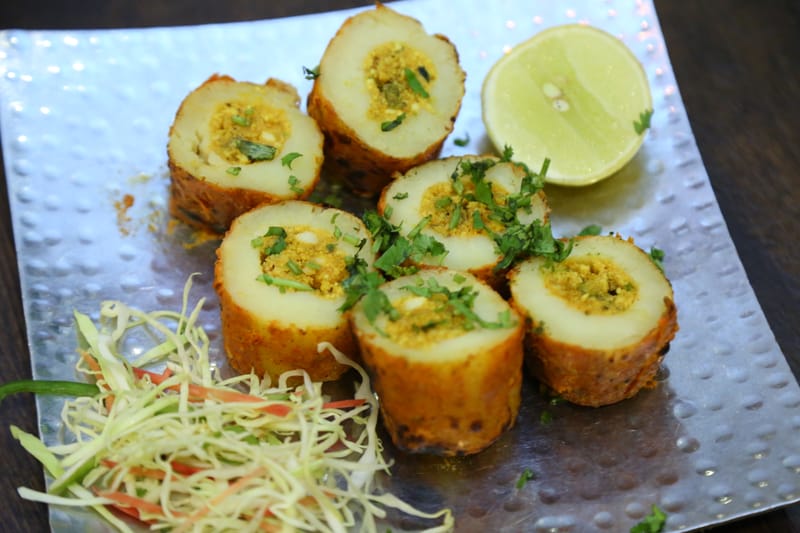 Stuffed tandoori potato rolls garnished with coriander