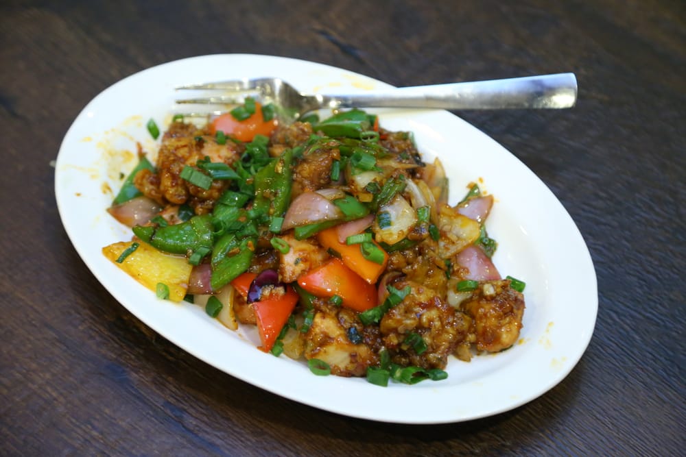 Chilli chicken with bell peppers and scallions in a glossy sauce